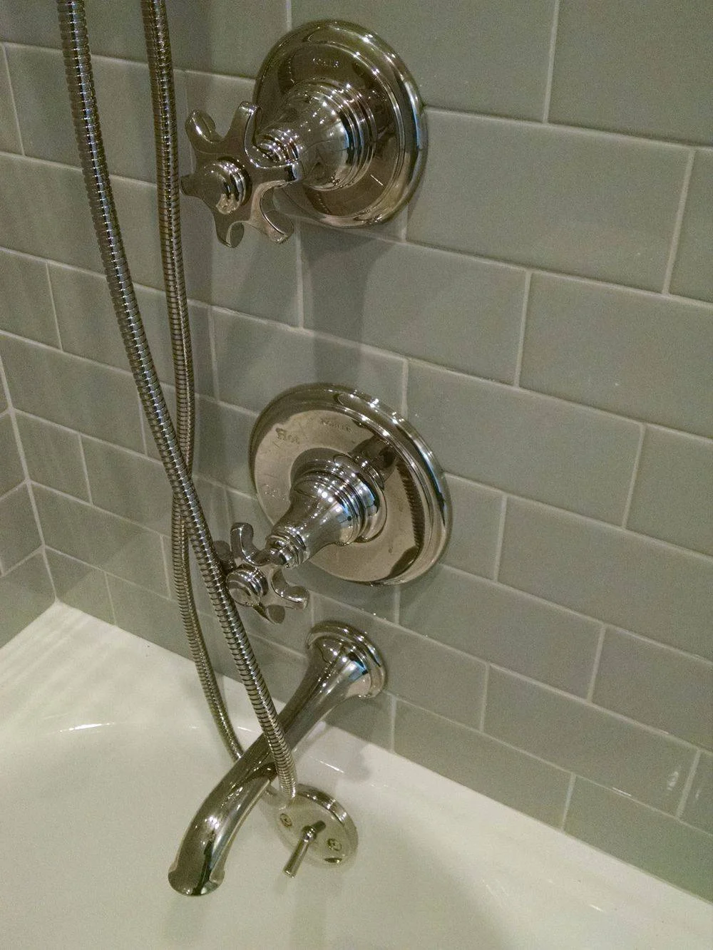 Premium chrome shower fixtures on subway tile wall